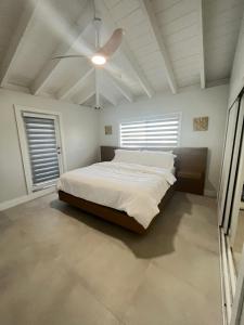 a bedroom with a bed and a ceiling fan at Blackbeard Retreat in Little Torch Key +54 photos