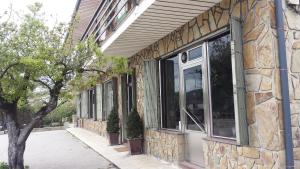 a building with large windows on the side of it at El Crucero in La Magdalena