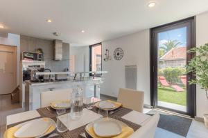 a kitchen and dining room with a table and chairs at La villa d'Alix avec jardin et parking in Bègles