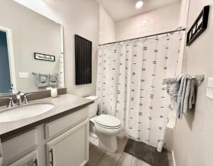 a white bathroom with a toilet and a sink at Cozy Chasm Cottage in Loveland +25 photos
