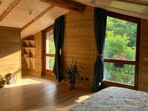 a bedroom with a bed and a large window at Le Moline b&b in Masserano