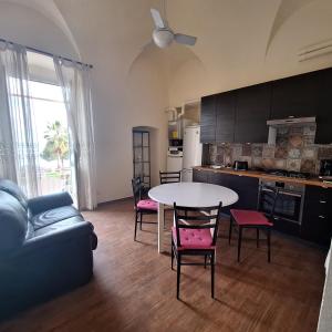 una cucina e un soggiorno con tavolo e sedie di B&B 47 a Loano