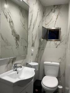 une salle de bain avec toilettes, lavabo et miroir dans l'établissement Summer Me - Corfu Downtown Studios, à Corfou 25 autres photos
