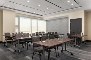 a conference room with tables and chairs and a chalkboard at Hyatt House Mississauga / Airport Corp Center in Mississauga