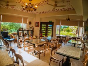a restaurant with tables and chairs and windows at Mei Jung B&B in Zhixue