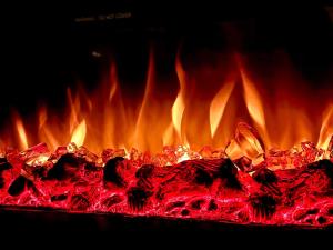 a fire in a grill with red and yellow flames at Alpine Charm Borovets Apart in Borovets +24 photos