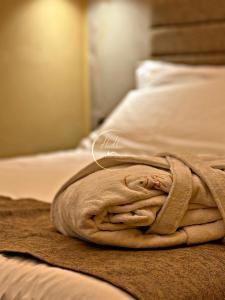 a towel sitting on top of a bed at Haven Home Suite & Spa in Catania +7 photos