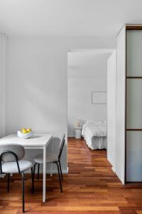 a dining room with a table and chairs and a bed at Cozy Studio in City Centre in Helsinki