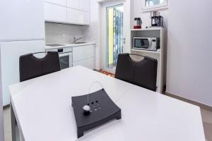 a kitchen with a white table and two chairs at Casa di Patrizia in Rome
