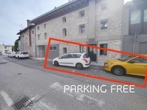 a white car parked in a parking lot next to a building at Loft dal design raffinato a Vigonovo in Fontanafredda