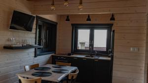 a kitchen with a table and a sink and a window at Jutrzenka in Międzybrodzie Kobiernickie