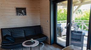 a living room with a couch and a table at Jutrzenka in Międzybrodzie Kobiernickie +16 photos