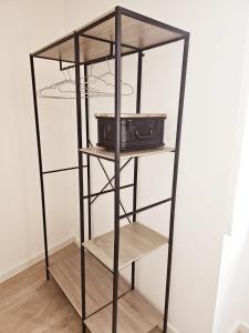 a black book shelf with two baskets on it at Alcamim Guesthouse in Elvas +81 photos