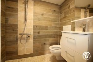 a bathroom with a toilet and a shower at La maison du village in Bajonnette +17 photos