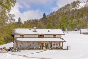 a house is covered in snow in the snow at Agriturismo Pian Formosa in Pian Formosa