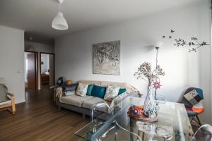 a living room with a couch and a glass table at SMOOTH T3 APARTMENT in Ponta Delgada +39 photos