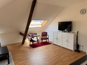 a living room with a tv and a table and chairs at Hobacher0503 in Lucerne