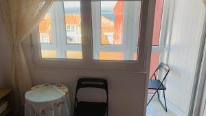a room with a window and a chair and a table at Pension Lopez in Fisterra +27 photos