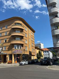 a large building with cars parked in front of it at ALEXA Chic Design Apart up to 5 persons - Paid Parking - Superfast Wifi in Berlin