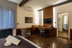 a hotel room with a desk and a bed at La Loggia Historic Resort - Albergo Diffuso in Gradara