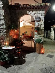 an entrance to a patio at night with a table at Casa Marina, Cilento Appartamento Suite indipendente in Ceraso