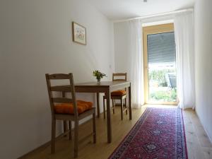 a dining room with a table and chairs and a window at Ferienwohnung Mit Garten Im Schönen Tannheim in Tannheim