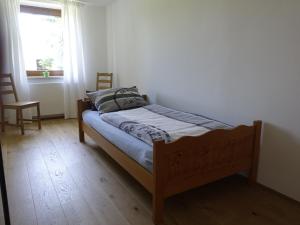 a bed in a room with a window at Ferienwohnung Mit Garten Im Schönen Tannheim in Tannheim +12 photos