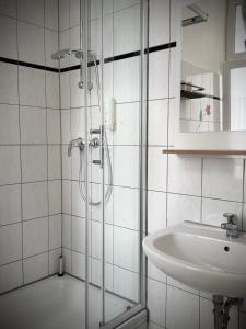 a bathroom with a shower and a sink at Erlanger Hof in Berlin +61 photos