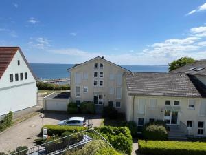 a view of two buildings and the ocean at Apprtementhaus Victoria - WE B 06 - Stranddüne in Sassnitz