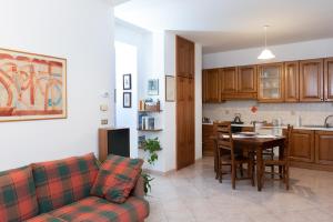 a living room and kitchen with a couch and a table at Xenia in Castrovillari +19 photos