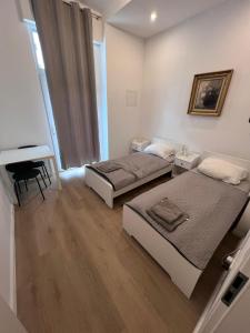 two beds in a room with a piano at 2-Rooms apartment in Berlin in Berlin