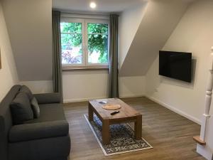a living room with a couch and a coffee table at Naturblick in Hennstedt