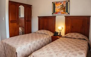 Voodi või voodid majutusasutuse Saba Arawak Hotel toas