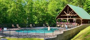 a swimming pool with a gazebo and a house at Honeymoon Sweet in Townsend