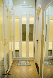 a room with four glass doors and a wooden floor at Tom Homestay - Vinhomes Grand Park in Long Bình