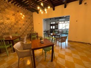 a dining room with tables and chairs in a room at Nicte Ha Campeche in Campeche