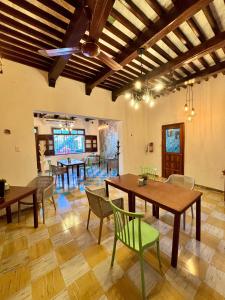 a dining room with wooden tables and chairs at Nicte Ha Campeche in Campeche