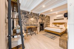 a bedroom with a bed and a stone wall at North House - Gorgeous 3 Bedroom 2-floor Old Quebec Townhouse in Quebec City