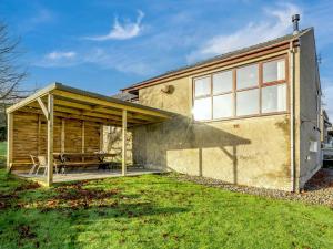 a house with a patio and a table at 4 Bed in Duddon Valley 89418 in Ulpha