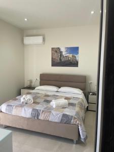 a bedroom with a bed with towels on it at maraneri rooms in Bovalino Marina