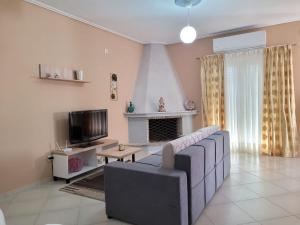a living room with a couch and a fireplace at House Rooms Korce in Korçë