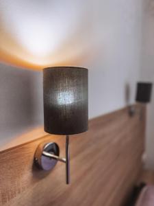 a lamp sitting on top of a wooden table at Sobri Halászcsárda és Panzió in Baja