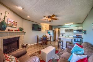 a living room with a couch and a fireplace at Riverpalooza RRC A305 in New Braunfels