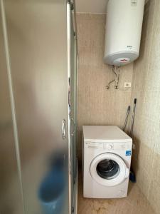 a laundry room with a washing machine and a washer at 9apartaments shengjin in Lezhë
