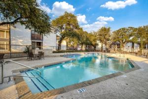 a swimming pool with blue water in a courtyard at Stratton 2501f I Comfy 2 Bed 2 Bath in Arlington