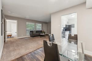 a living room with a glass table and chairs at Stratton 2501f I Comfy 2 Bed 2 Bath in Arlington