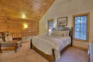 a bedroom with a bed and a wooden ceiling at Snowbird Sanctuary Snowbird Nest Hot tub mountain luxury firepit in Mineral Bluff