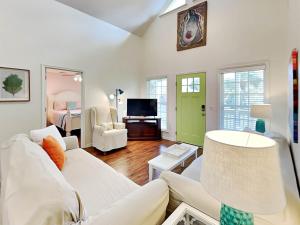 タイビーアイランドにあるBack River Bungalowの白いソファとテレビのあるリビングルーム