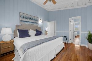a bedroom with a large bed with blue walls at Channel Vibes in Myrtle Beach +100 photos