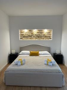 a bedroom with a large bed with two towels on it at Home holiday Kalanto in Castellammare del Golfo